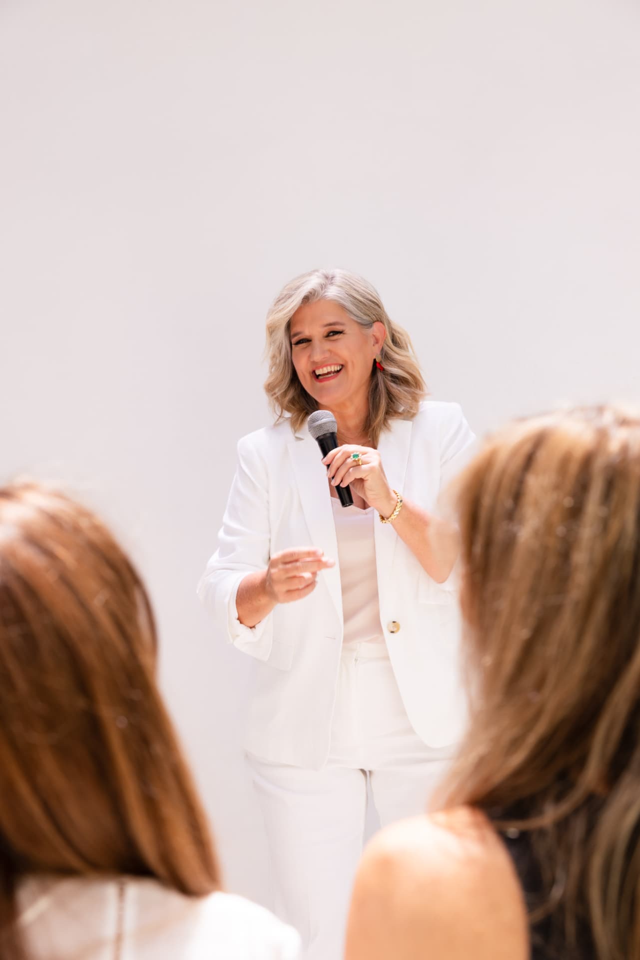 Dolores holding the mic in front of a group